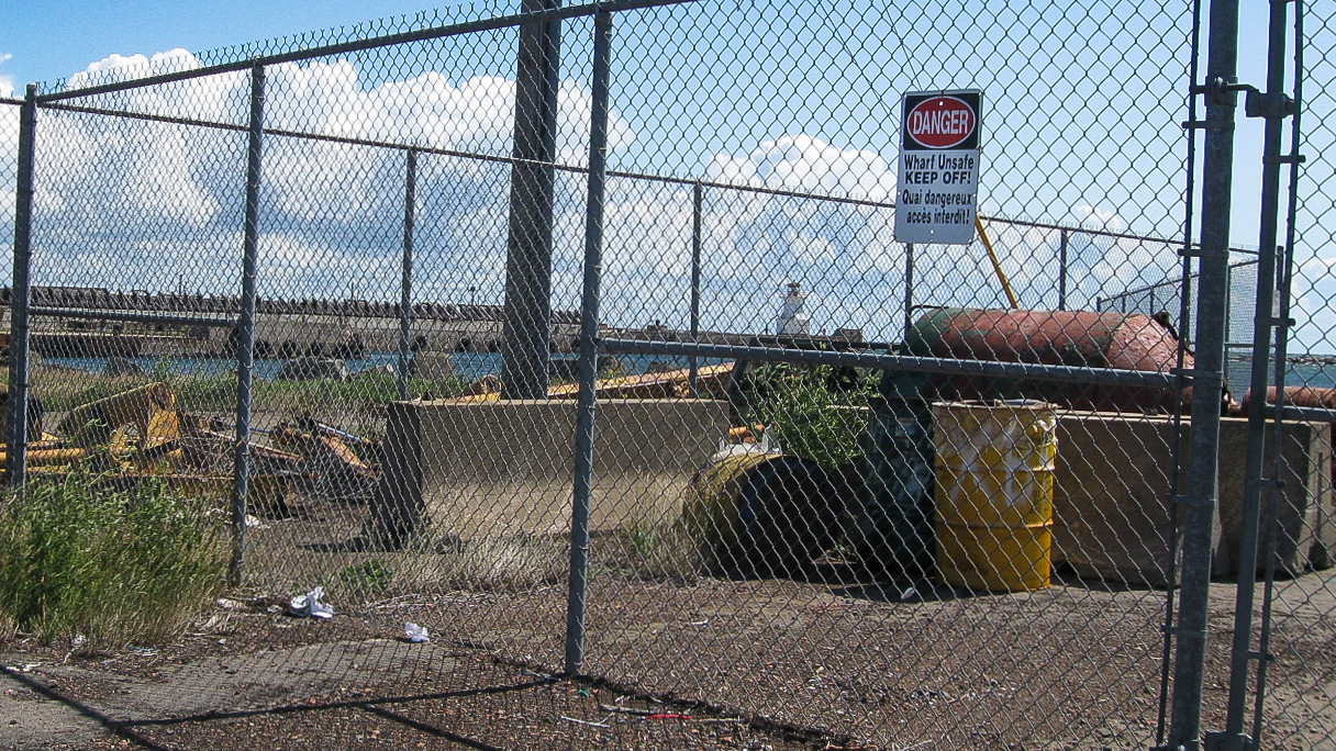 chain link fence with wharf usage sign