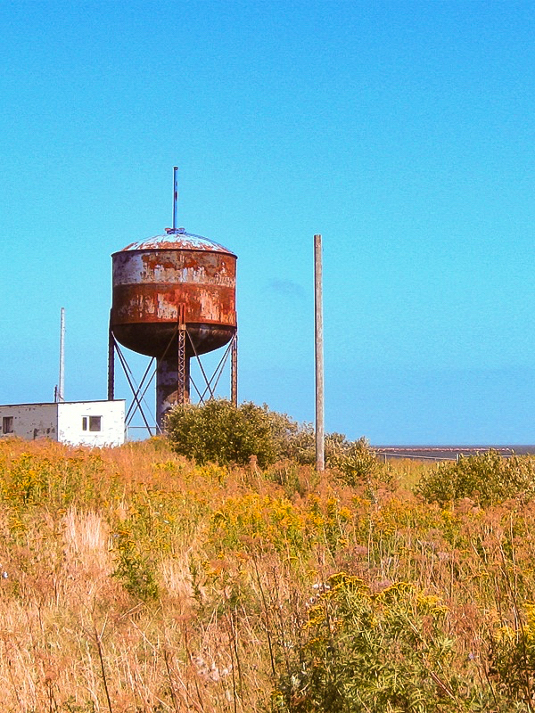 rusted water tower on a sunny day