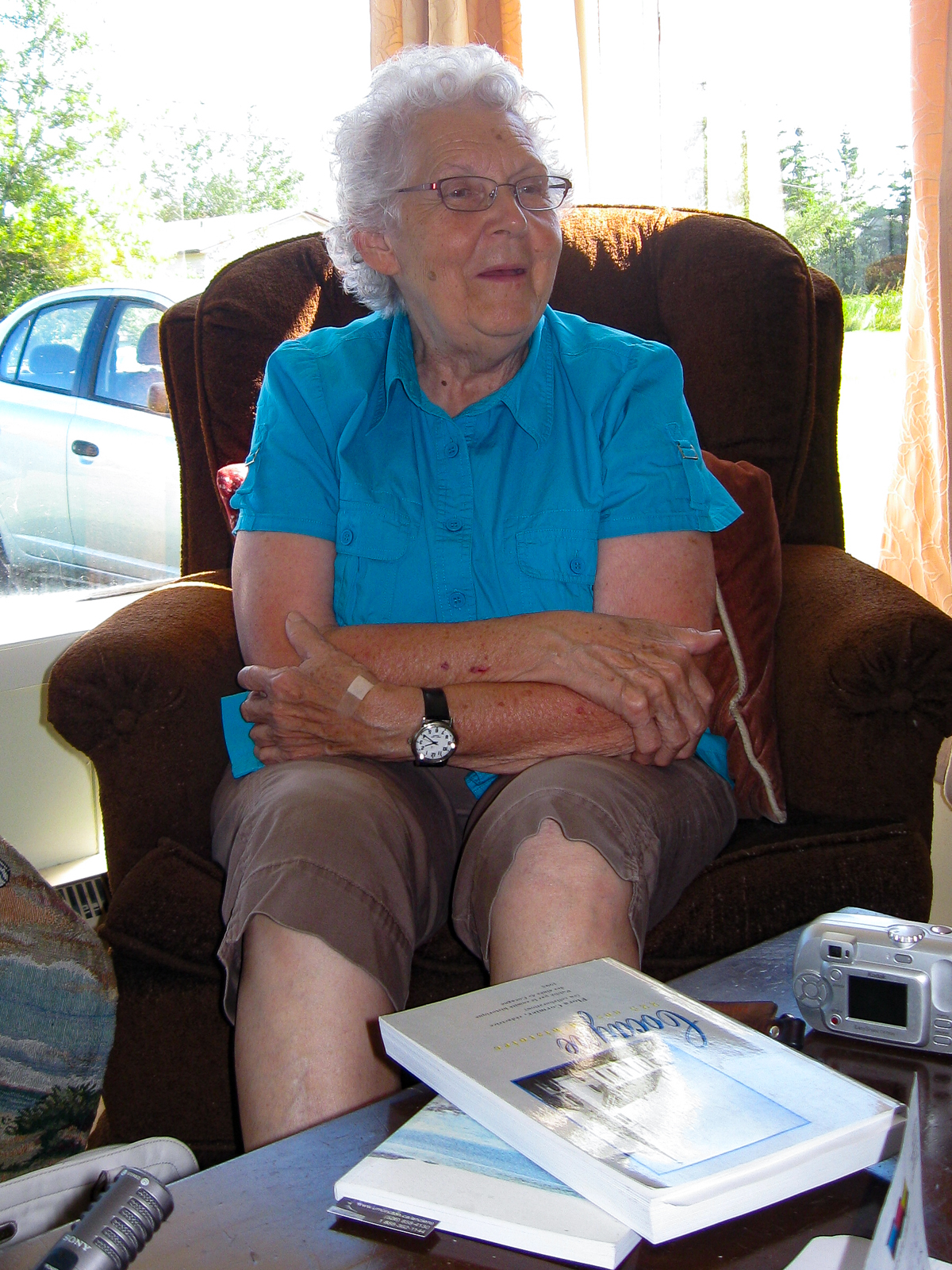 older woman in chair talking