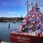 fishing boat strewn with Acadian flags